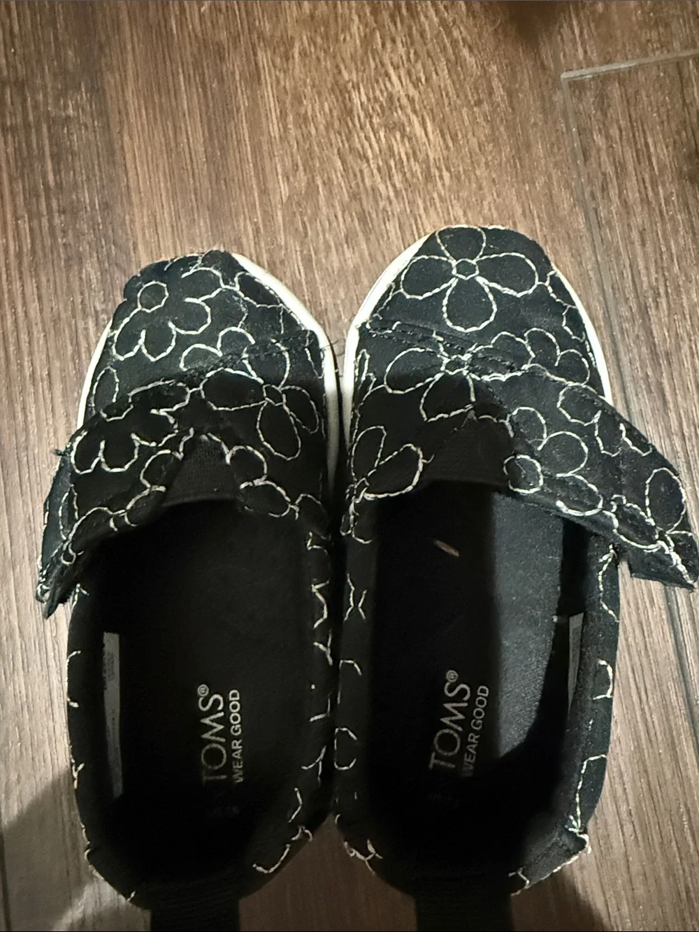 TOMS Kids Black Slip-On Shoes with White Floral Stitching